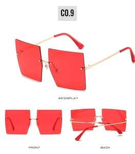 Detail view of red rimless oversized square sunglasses with elegant gold metal temples