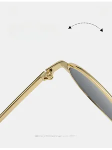 Macro shot of durable polished gold metal hinge with precision screw on retro sunglasses