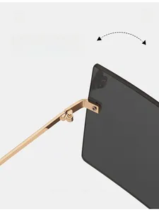 Close-up of durable golden metal hinge and structural detail of rimless sunglasses