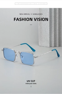 Detail of square silver metal sunglasses with light blue lenses on a stone display