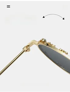 Detalle de bisagra de metal dorado y adornos de strass en gafas de sol ovaladas elegantes