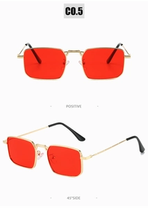 Detail of retro rectangle sunglasses featuring red lenses and golden metal frame