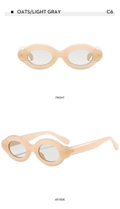 Macro detail of oats and light gray oval sunglasses showing thick frames and side curves