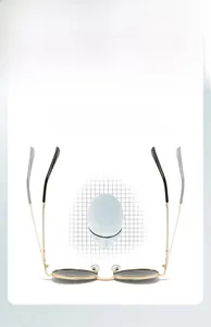 Detail view of flexible gold metal temple arms on retro round frame sunglasses