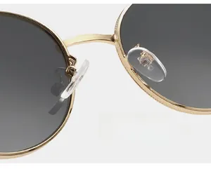 Detail of eco-friendly silicone nose pads on gold metal round sunglasses frame