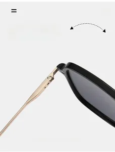 Detail of durable texture metal hinge connecting black frame and gold sunglasses temples