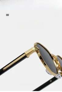 Detail of premium oval sunglasses showing gold metal hinges and transparent nose pads