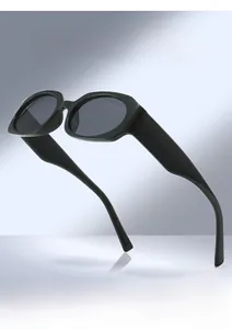 Detailed view of thick black geometric frame sunglasses with dark polarized lenses