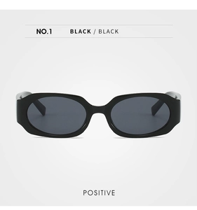 Detail of vintage small frame oval sunglasses with sleek black glossy finish and lenses
