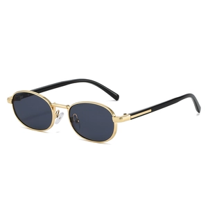 Retro oval gold metal frame sunglasses with dark grey lenses in a minimalist designer style