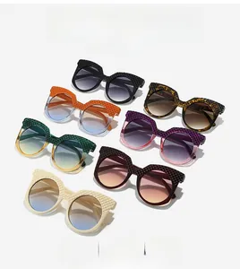 Detailed view of oval oversized sunglasses featuring distinctive quilted textured frames