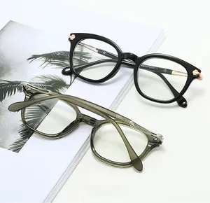 Detail of vintage round TR90 glasses frames in black and olive green on a magazine