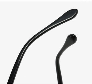 Macro shot of ergonomic black glossy eyeglass temple tips with smooth streamlined design