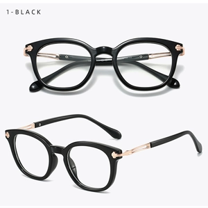 Detail of retro black TR glasses frame with rose gold metal accents and side rivets