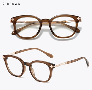 Detail of retro round glasses frame with brown texture and engraved metal temples