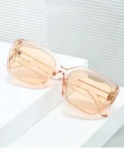 Detail of peach pink rectangular computer glasses with visible metal temple reinforcement