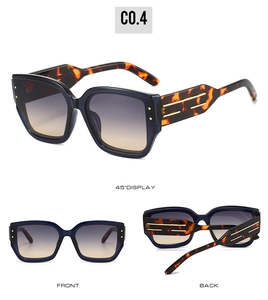 Detail view of square cat-eye sunglasses with gradient lenses and leopard print temples
