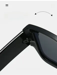 Macro detail of high-gloss black sunglasses showing durable silver metal hinges