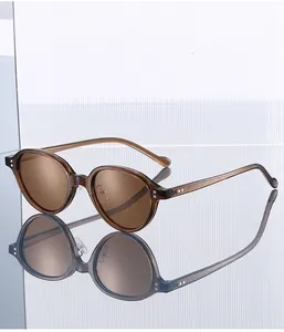 Close-up of brown oval sunglasses hinge and temple markings with mirror reflection