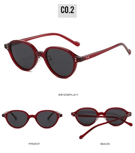 Macro view showing vintage burgundy oval frame sunglasses with metallic rivets and black lenses