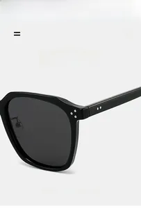 Detail of matte TR90 black sunglasses showing metal rivets and lightweight texture