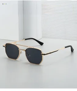 Close-up of golden metal double bridge and dark lenses on square aviator sunglasses