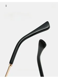Detail of curved black temple with golden metal hinge for square fashion sunglasses
