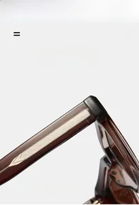 Macro detail of transparent amber sunglasses temple with decorative metal core insert