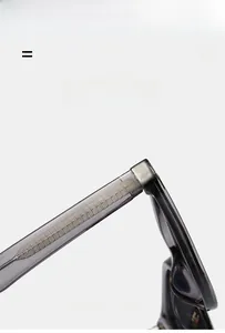 Detailed close-up of grey translucent eyewear frames with grid-patterned metal hinge structure