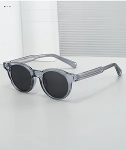Detailed side view of grey translucent round sunglasses frame with reinforced metal core