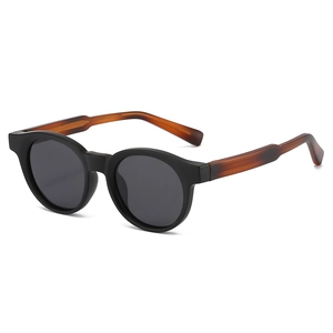 Vintage round frame sunglasses with matte black fronts and amber tortoiseshell temples