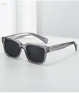 Detail of square polarized sunglasses featuring transparent gray frames and metal inner core