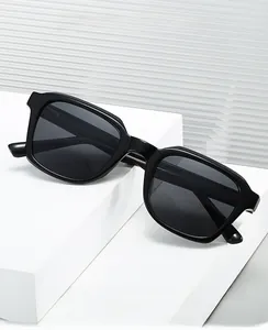 Detail of premium black thick-frame computer safety glasses on a geometric white stand