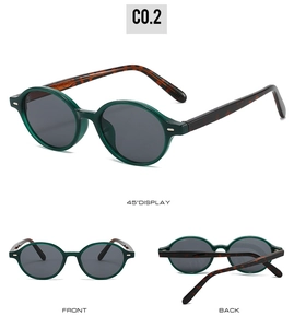 Detail view of round forest green sunglasses with tortoiseshell temples and grey lenses