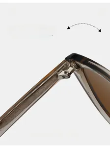 Macro shot of durable silver metal hinges on translucent tea-colored cat-eye sunglasses