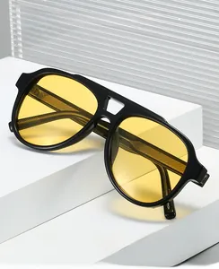 Fashionable pilot sunglasses featuring bold black frames and bright yellow transparent lenses