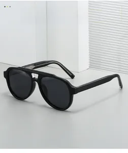 Detail of black aviator sunglasses with silver bridge accent and UV protection lenses