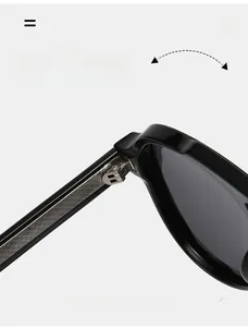 Macro detail of high-gloss black aviator sunglasses showing the durable metal hinge structure