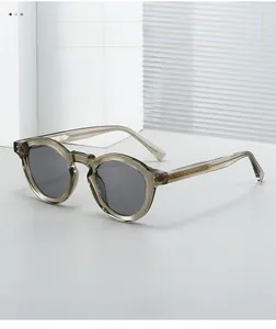 Detail of vintage round sunglasses with grey tea acetate frame and metal core engraving