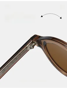 Detail of high-quality metal hinge structure on vintage round translucent brown sunglasses