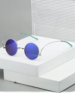 Close-up of 1960s hippie retro round silver metal sunglasses with blue coated lenses