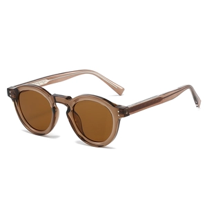 Vintage round tortoiseshell sunglasses with metal rivets and amber lenses on white background