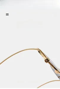 Detail of gold metal frame glasses showing durable hinges and flexible temple structure