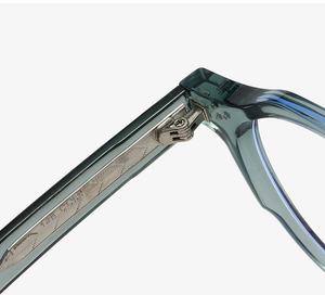 Detailed close-up of teal acetate glasses frame with engraved metal feather core wire