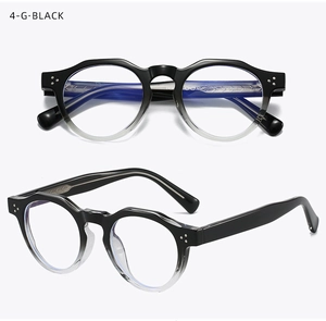 Detail of retro round black gradient eyeglass frames with silver rivet accents