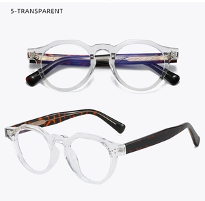 Detail of round transparent glasses frames with tortoise temples and gold metal core