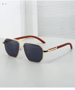 Détail de lunettes aviateur avec monture en métal doré et branches en grain de bois