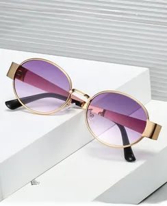 Detail of gold metal frame with floral engraving and purple gradient lenses