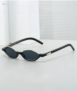 Detail of retro cat-eye sunglasses featuring black frames with gold metal inlay accents