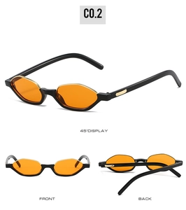 Detail view showing black half-frame cat eye sunglasses with orange lenses and gold trim